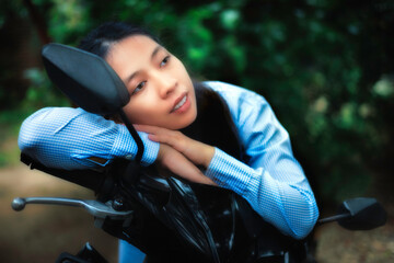 Indonesian girl sitting on a motorcycle