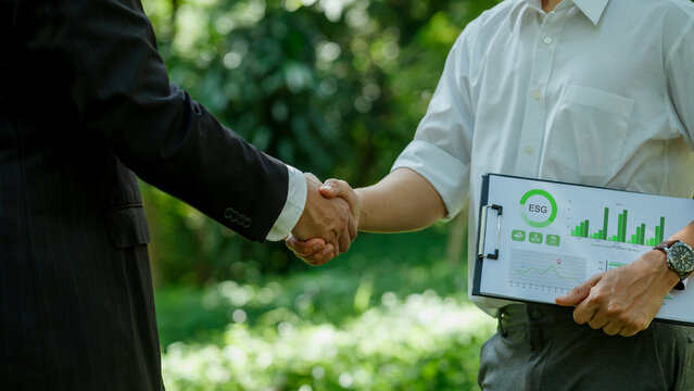 World Environment Day.ESG. business partner colleagues shaking hands working together in sustainable development goal. Sustainable business.Business value chain and Growing sustainability.CSR.