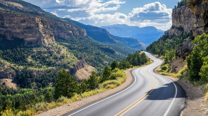 Fototapeta premium A scenic mountain road with dramatic cliffs and breathtaking views, leading into the horizon.