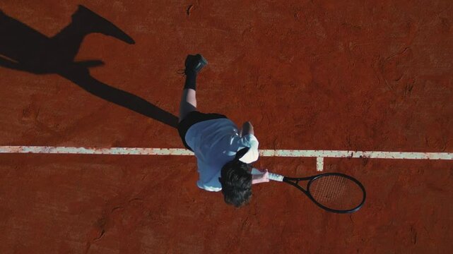Aerial flat lay shot of a montage of a teenager boy serving during a tennis match on a clay court.