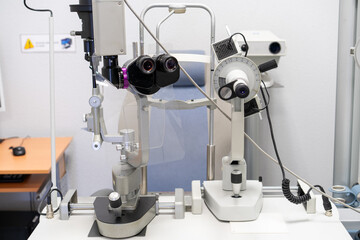 Close-up of a slit lamp in an ophthalmology clinic used to examine the eyes. This specialized microscope illuminates and magnifies ocular structures.