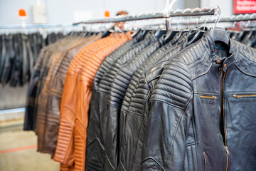 Obraz premium Row of leather motorcycle jackets neatly displayed, highlighting rugged style and protective gear for riders. Concept of biker fashion, durability, and essential safety apparel.