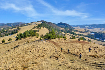 Group of tourists is going on a trip in the Małe Pieniny Mountains.  Tourists on the hiking trail in the mountains. Active healthy lifestyle.