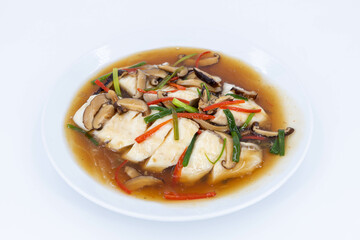 Sea bass fillet steam with soy sauce, Steamed fish in soy sauce broth, garnished with fresh mushrooms, julienned ginger, red chilies, and spring onions, Thaifood