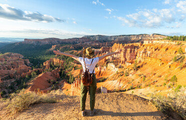 Girl relaxing on vacation hiking trip. Woman standing next to Thor's Hammer hoodoo on top of ...