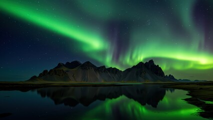 Aurora borealis illuminates Icelandic mountains and reflective waters at night Scenic landscape evokes tranquility and adventure