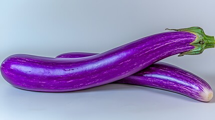 Two Fresh Purple Eggplants Displayed on a Light Background for Culinary Inspiration