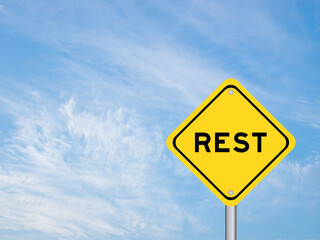 Yellow transportation sign with word rest on blue color sky background