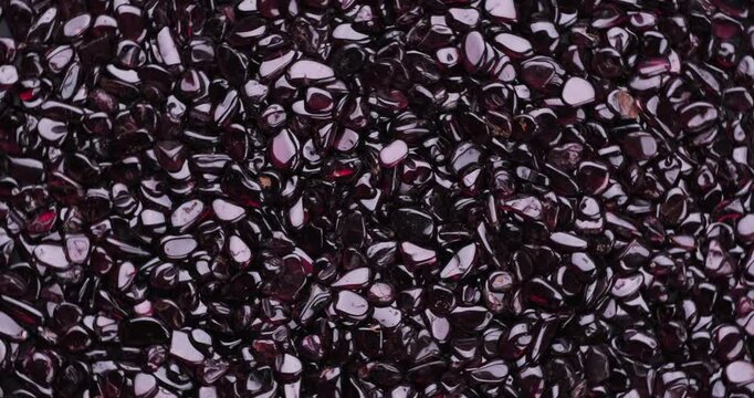 Top view of stack of polished Red whine Garnet chips turning 360&deg;.