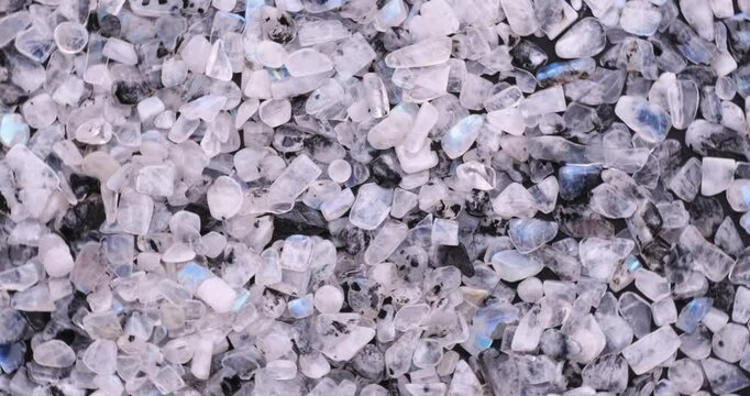 Top view of stack of polished clear Moonstone Labradorite with blue labradorescence chips turning 360&deg;