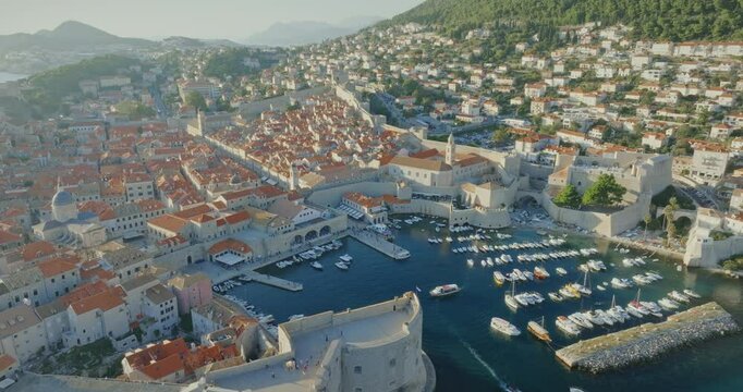 A stunning aerial view of the historic city of Dubrovnik on Croatia&rsquo;s Adriatic coast. Surrounded by medieval walls, the city is characterised by orange-tiled roofs, a historic port and narrow streets.