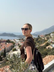 Naklejka premium Coastal travel portrait of a woman by the sea, digital nomad and retreat vibe, blue water and island bay, summer vacation lifestyle, wellness slow travel and mindful escape, scenic background with cop