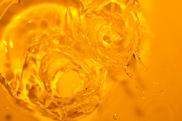 Vibrant Close-Up of Water Splashes Against Golden Background