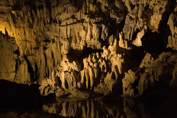 Rock formations of Betharram caves in France during a serene midday excursion