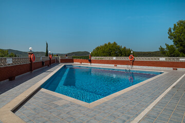 Serene outdoor swimming pool with crystal-clear blue water and scenic mountain backdrop