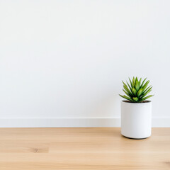 Fototapeta premium Small potted plant in minimalist white pot on wooden floor, adding touch of nature to space