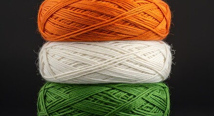 Tricolor Yarn Balls: A vibrant stack of orange, white, and green yarn balls, reminiscent of the Indian flag, set against a dark background.