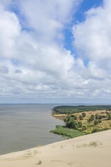 Obraz premium Beautiful landscape of Curonian Spit sand dunes by Baltic Sea Curonian Lagoon, which is inscribed on the UNESCO World Heritage List. Sand buried villages, Lithuania