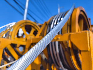 A large wooden spool of high-voltage electric wires is located on the road