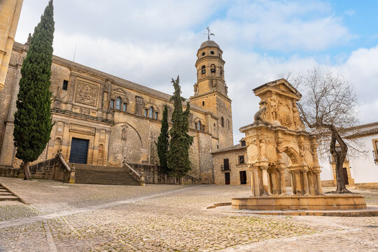 Catholic cathedral of the city of Baeza and fountain in the square medieval style, Andalusia.