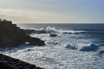 Waves crashing on cliffs at dusk........