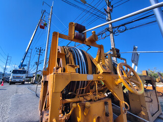 Installation of high-voltage electric wires on new poles along the road