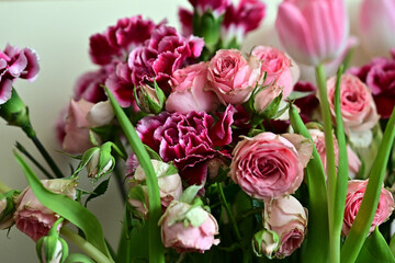 a bouquet of colorful roses and tulips