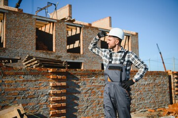 Construction worker in uniform and safety equipment have job on building