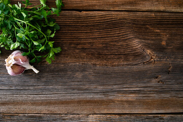Empty wooden table - empty pine boards with parsley and garlic