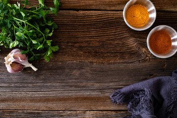 Empty wooden table - empty pine boards with parsley, garlic and spices	