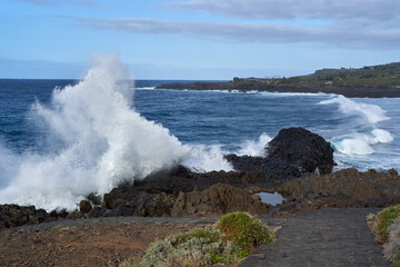 Waves crashing against volcanic rocks........