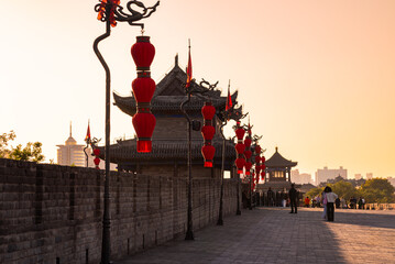 Old wall in Xian, China with traditional towers and red lanterns