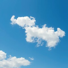 Fototapeta premium Soft white clouds drift across a brilliant blue sky, soft, blue