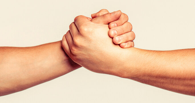 Friendly handshake, friends greeting, teamwork, friendship. Helping hand outstretched