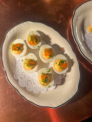 Six devilled eggs on a plate