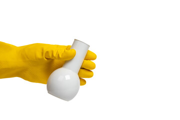 Yellow gloved hand holding a white porcelain lab flask on isolated white background. Science, experiment, research and laboratory concept
