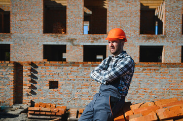 Construction worker in uniform and safety equipment have job on building