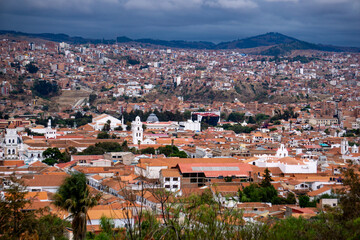 Fototapeta premium Panoramic View Of Sucre Bolivia Under Dark Storm Clouds A Scenic Cityscape Of The Historic White City With Colonial Architecture And A Dramatic Sky