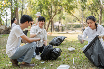 Dedicated volunteers sorting trash during a community cleanup, promoting eco-friendly practices and...