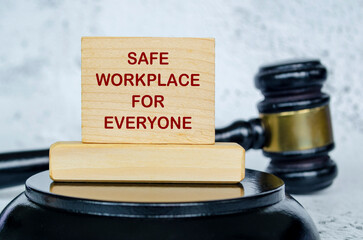 Safe workplace for everyone text written on wooden board with lawyer gavel background. Harassment...