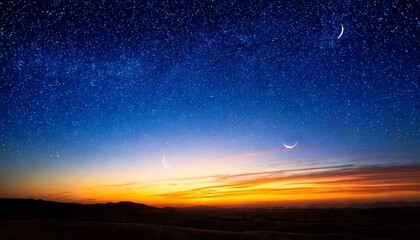 Fototapeta premium A twilight sky with a gradient from dark blue to orange features two crescent moons and a sprinkling of stars above a silhouetted horizon.