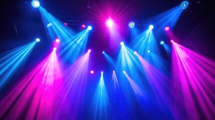 A wide-angle shot of vibrant concert lighting with blue and pink beams radiating from the stage and surrounding air, providing ample copy space for event branding or messaging.