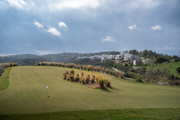 Aerial View of a Scenic Golf Course Surrounded by Hills