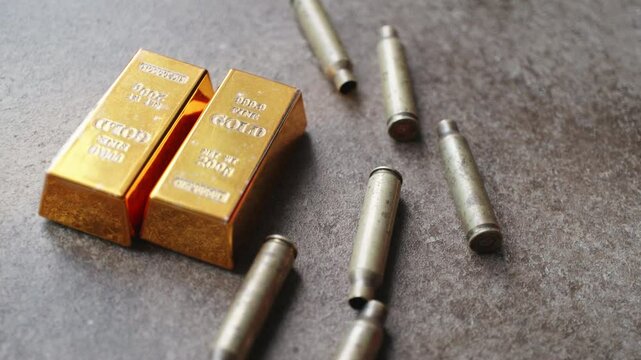 gold bars and bullet casings on brown background