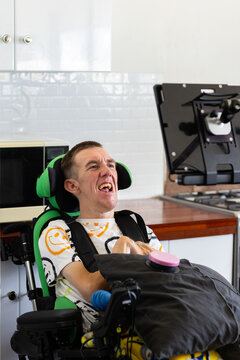 Young man with disability on his wheelchair looking on an acc screen