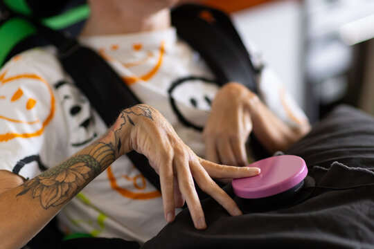 Young disabled man pressing the talking button device.