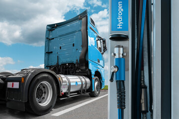 A hydrogen fuel cell semi truck with H2 gas cylinder onboard next to filling station. Eco-friendly...