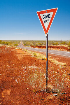 Give way sign in front of a long stretch of highway between Katherine and Tennant Creek,.