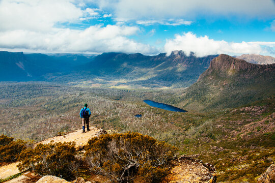 A hiker on the way up Mt Ossa high above Pinestone Valley with the Du Cane Range in the background.