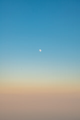 moon in the sky, Natural background, sky at sunrise or sunset, color gradient from pink orange to blue, delicate and smooth transition